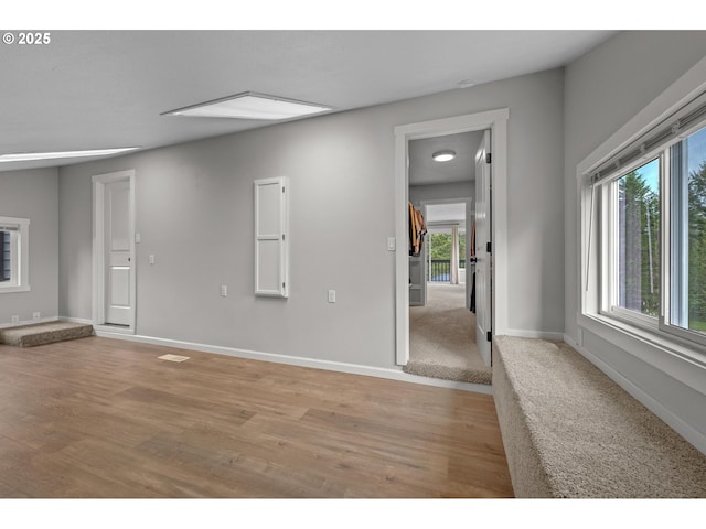 unfurnished room featuring light wood-style floors and baseboards