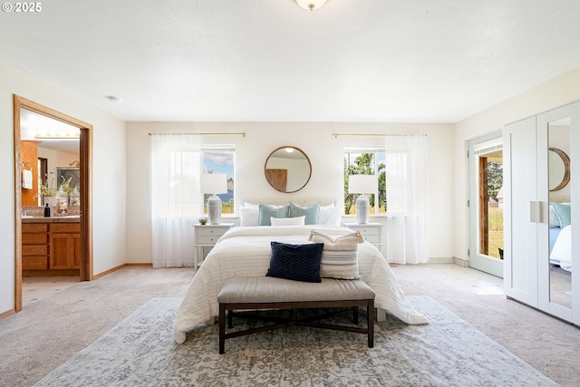 2395 88th Ave NE, Salem, OR 97305 - bedroom featuring light carpet, ensuite bath, and access to exterior