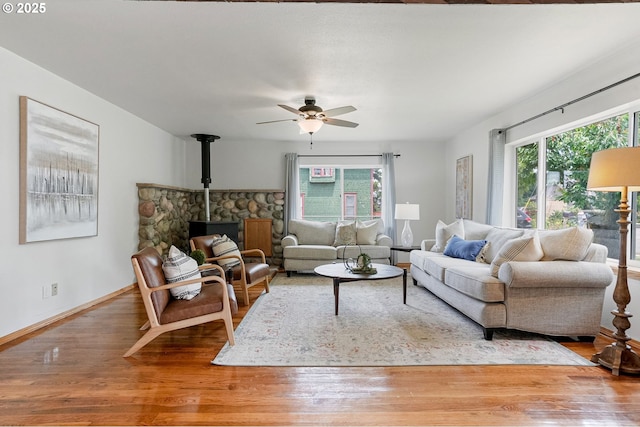 2395 88th Ave NE, Salem, OR 97305 - living room with wood finished floors, a wood stove, and ceiling fan