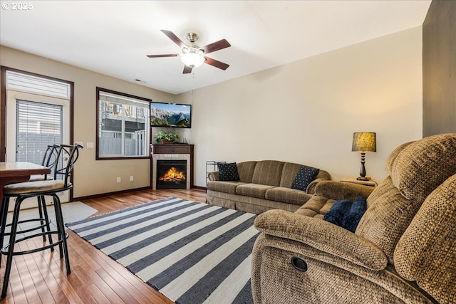 810 E 9th St Unit E18, Newberg, OR 97132 - living room with wood finished floors, ceiling fan, a tile fireplace, and baseboards