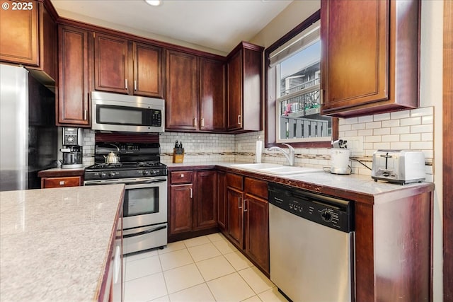810 E 9th St Unit E18, Newberg, OR 97132 - kitchen featuring appliances with stainless steel finishes, a sink, light countertops, and tasteful backsplash