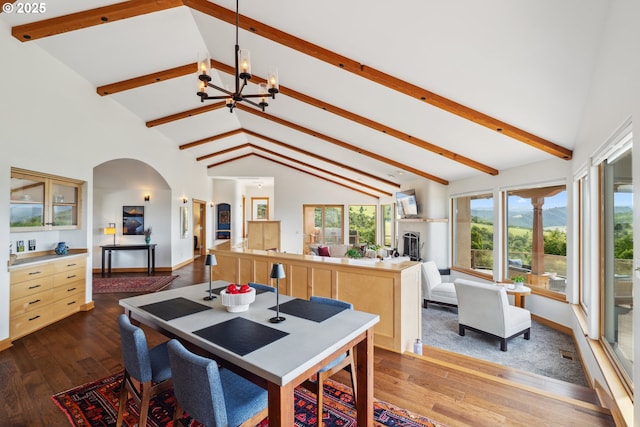 5331 Dolan Rd, The Dalles, OR 97058 - dining room with arched walkways, a chandelier, dark wood finished floors, beam ceiling, and high vaulted ceiling