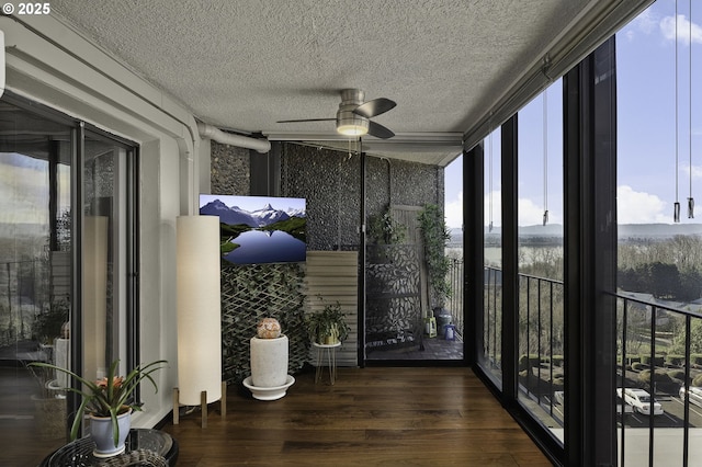 sunroom featuring ceiling fan