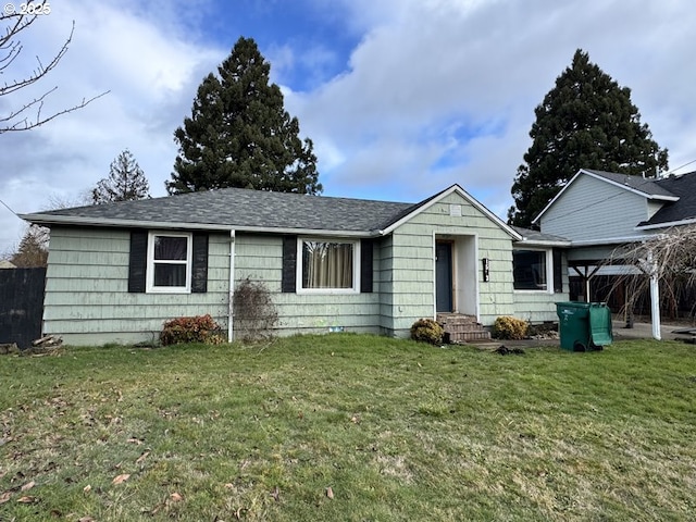 ranch-style home featuring entry steps and a front lawn