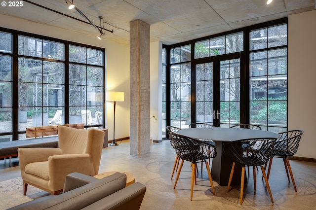 dining space with a wealth of natural light, french doors, and ornate columns