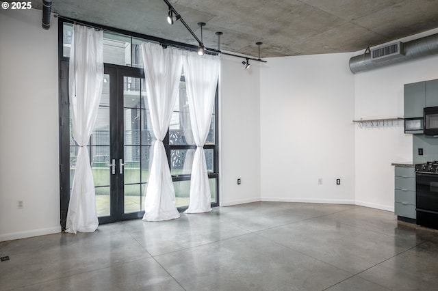 interior space with visible vents, baseboards, concrete flooring, and french doors