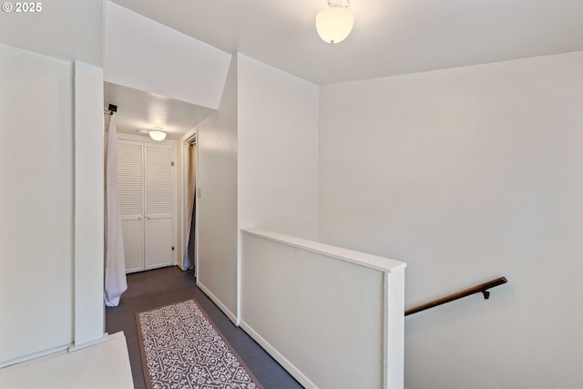 2720 Bowman Rd, Reedsport, OR 97467 - hall featuring an upstairs landing, dark wood-style flooring, and baseboards