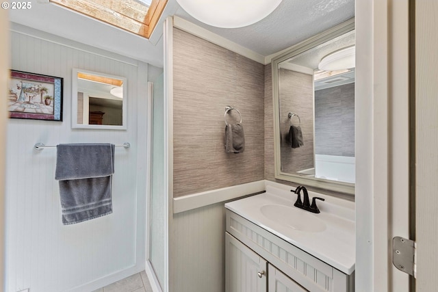 2720 Bowman Rd, Reedsport, OR 97467 - bathroom with vanity, a skylight, and tile patterned floors