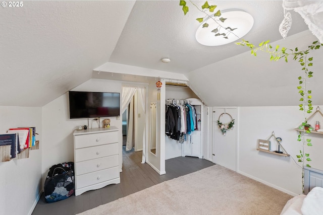 2720 Bowman Rd, Reedsport, OR 97467 - bedroom with a textured ceiling, baseboards, lofted ceiling, and wood finished floors
