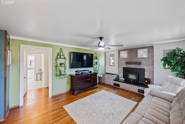 2720 Bowman Rd, Reedsport, OR 97467 - living room with wood finished floors, ceiling fan, ornamental molding, and baseboards