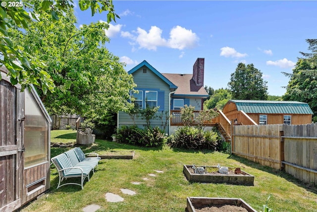 2720 Bowman Rd, Reedsport, OR 97467 - view of yard with a vegetable garden, a wooden deck, and stairs