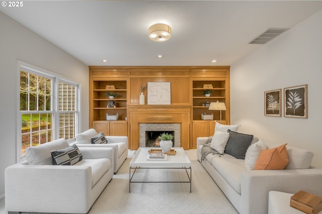 living room with visible vents, recessed lighting, and a fireplace