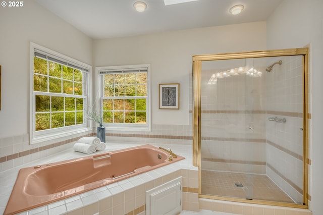 full bathroom with a garden tub and a stall shower