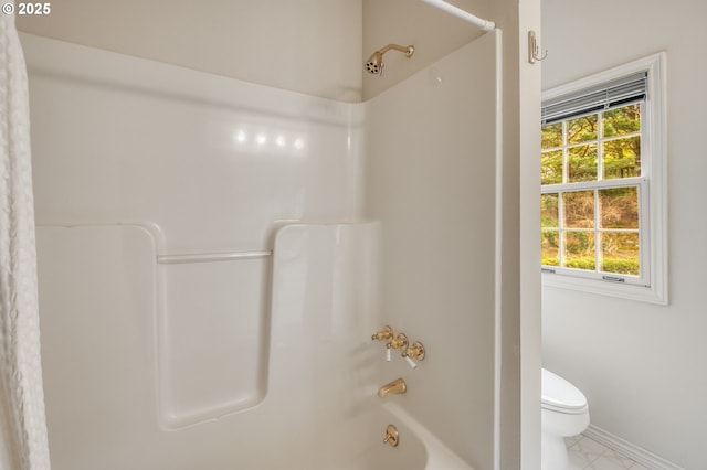 full bathroom featuring toilet, baseboards, marble finish floor, and shower / bathtub combination