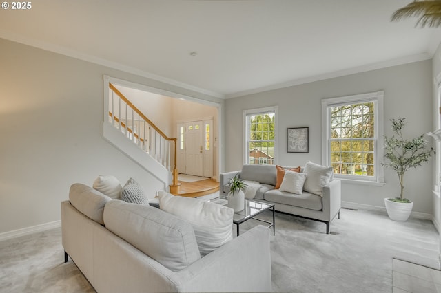 living room with baseboards, plenty of natural light, stairs, and crown molding