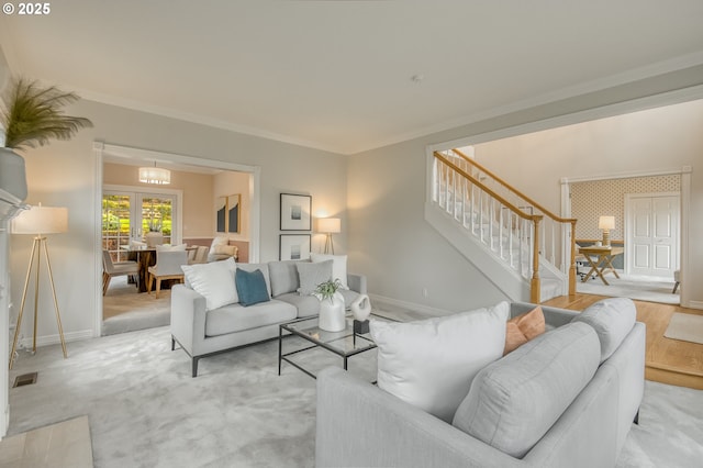 living area featuring stairway, visible vents, crown molding, and baseboards