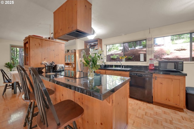 768 Brookside Dr, Eugene, OR 97405 - kitchen with black appliances, tile counters, and a breakfast bar