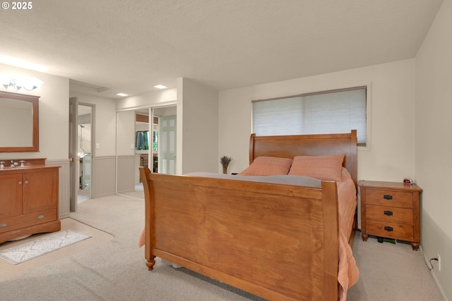 768 Brookside Dr, Eugene, OR 97405 - bedroom with light carpet, a closet, a wainscoted wall, and ensuite bath
