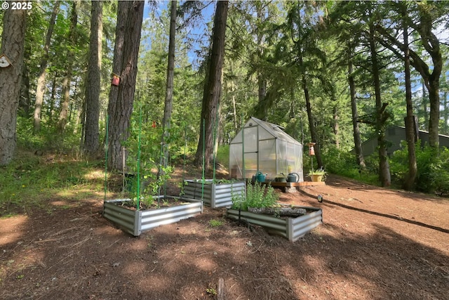 768 Brookside Dr, Eugene, OR 97405 - view of yard featuring a greenhouse, a garden, and an outdoor structure