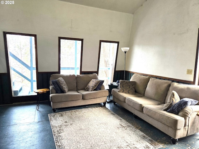 living room featuring a high ceiling and a wealth of natural light