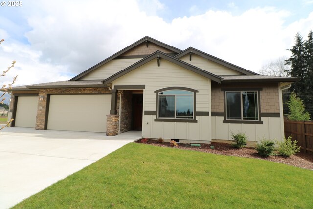 view of front of home with a garage and a front lawn