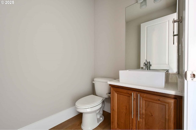 4909 NE 132nd Cir, Vancouver, WA 98686 - bathroom featuring toilet, vanity, wood finished floors, and baseboards