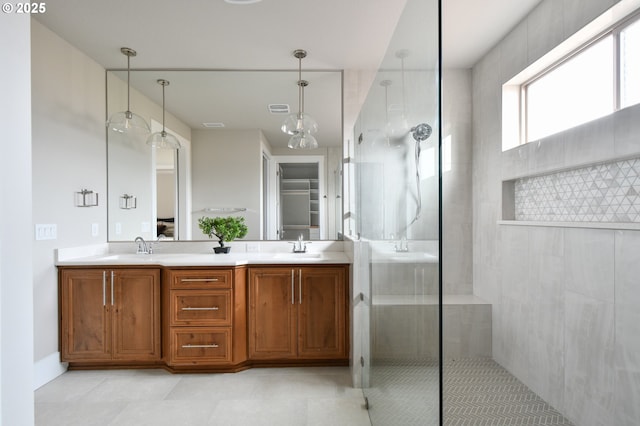 full bathroom with double vanity, visible vents, a sink, and walk in shower