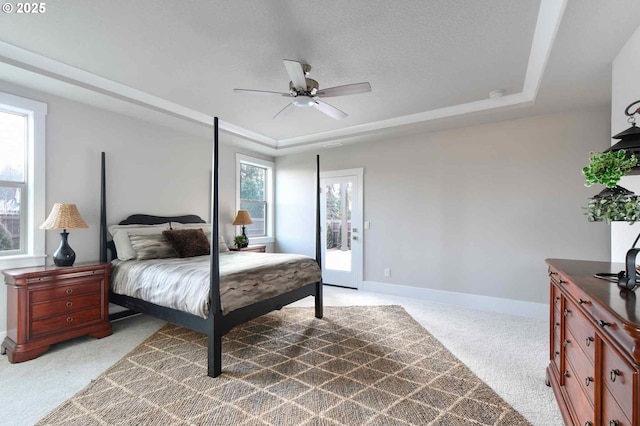 4909 NE 132nd Cir, Vancouver, WA 98686 - bedroom featuring a raised ceiling, light colored carpet, baseboards, access to outside, and a ceiling fan