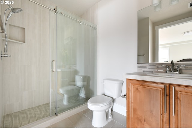 bathroom featuring a stall shower, visible vents, toilet, tile patterned flooring, and vanity