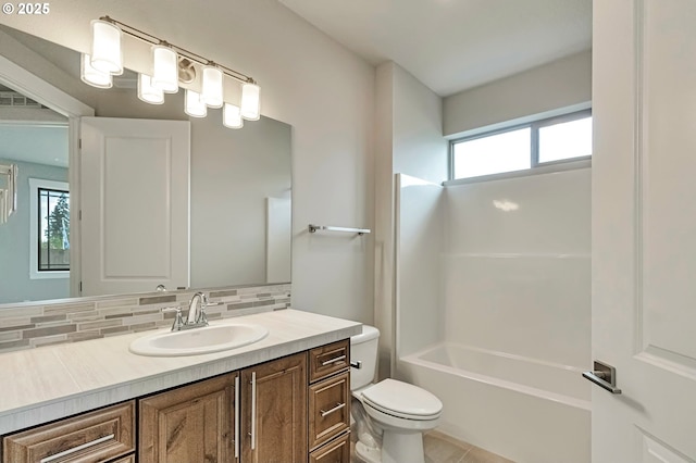 4909 NE 132nd Cir, Vancouver, WA 98686 - bathroom featuring healthy amount of natural light, decorative backsplash, toilet, and vanity