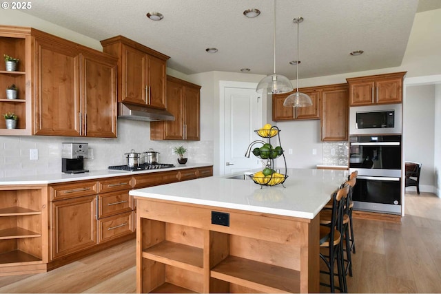 4909 NE 132nd Cir, Vancouver, WA 98686 - kitchen with open shelves, a sink, under cabinet range hood, appliances with stainless steel finishes, and a textured ceiling