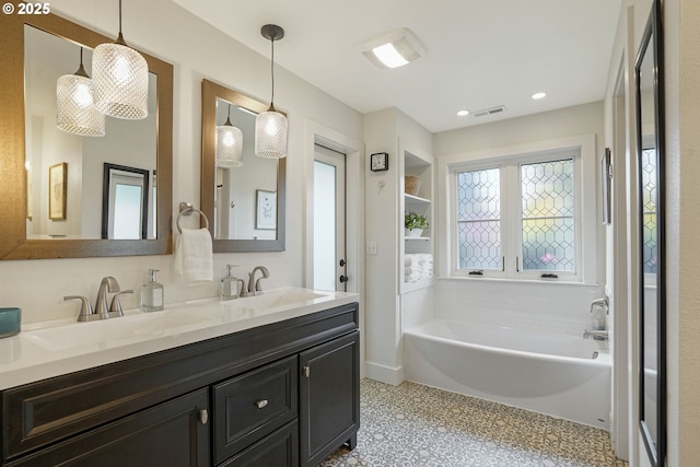 bathroom featuring vanity and a tub