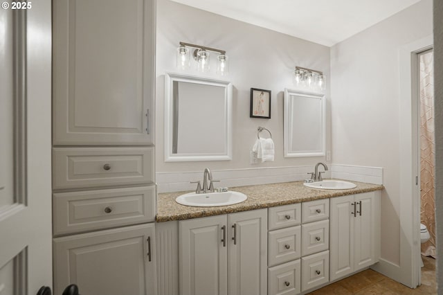 bathroom featuring vanity, tile patterned floors, and toilet