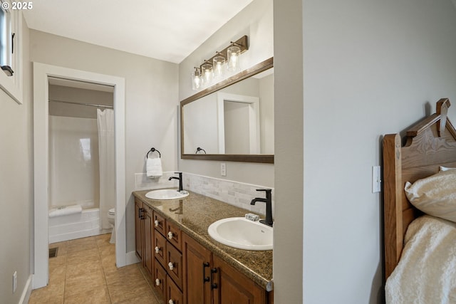 full bathroom featuring backsplash, vanity, shower / bath combination with curtain, tile patterned floors, and toilet