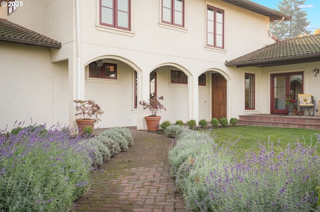 property entrance with a yard