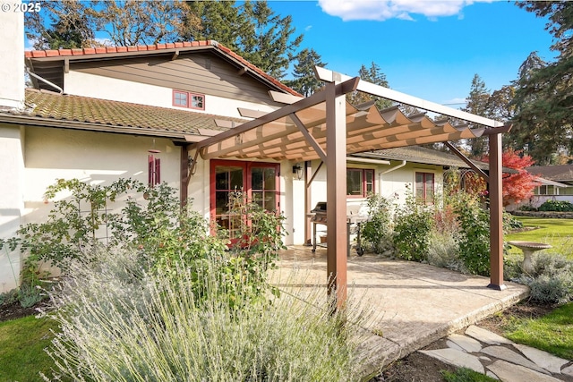 view of front of home with french doors, a patio, and a pergola