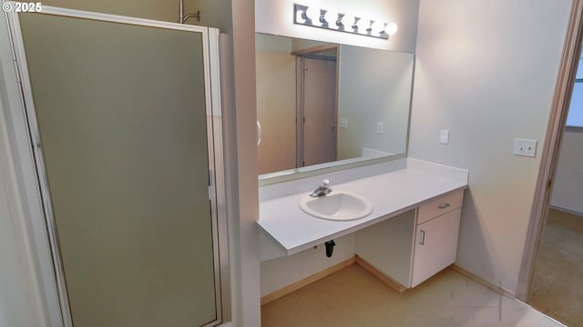 bathroom featuring vanity and a shower with shower door