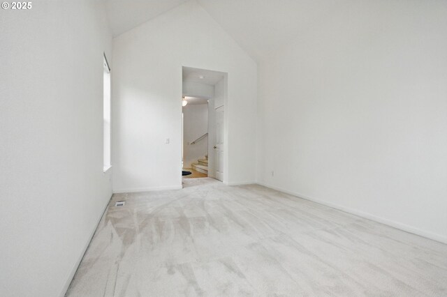 15820 SW Towhee Ln, Beaverton, OR 97007 - empty room featuring carpet flooring, stairs, vaulted ceiling, and baseboards