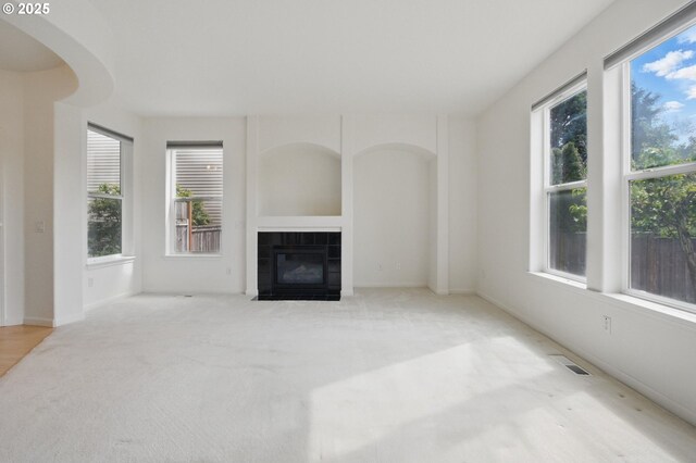 15820 SW Towhee Ln, Beaverton, OR 97007 - unfurnished living room with a tile fireplace, carpet flooring, and baseboards