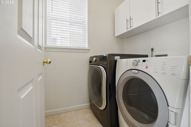 15820 SW Towhee Ln, Beaverton, OR 97007 - washroom with washing machine and dryer, cabinet space, baseboards, and light tile patterned flooring