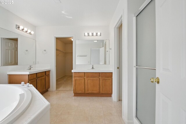 15820 SW Towhee Ln, Beaverton, OR 97007 - bathroom featuring two vanities, tile patterned floors, a garden tub, and a stall shower