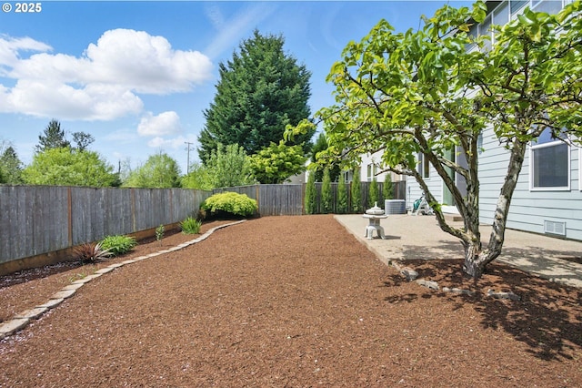 view of yard featuring central air condition unit and a fenced backyard