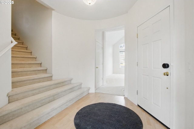foyer entrance featuring stairway and light wood finished floors