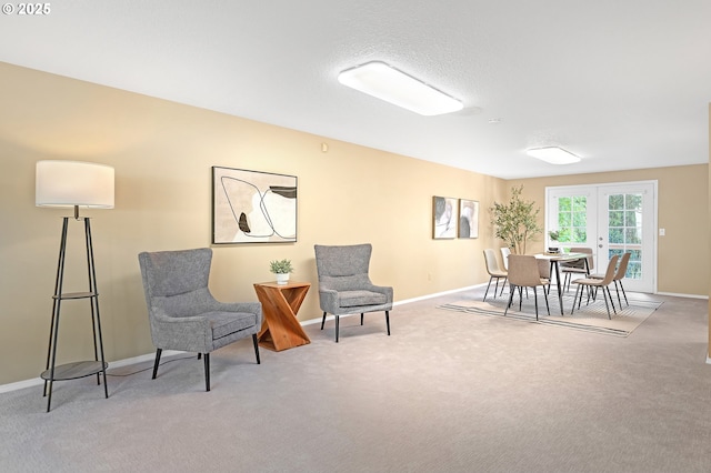 sitting room with carpet floors and baseboards