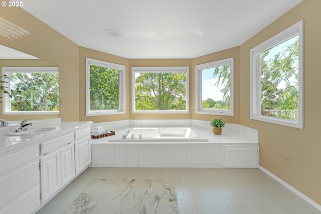 bathroom with plenty of natural light, a bath, vanity, and baseboards
