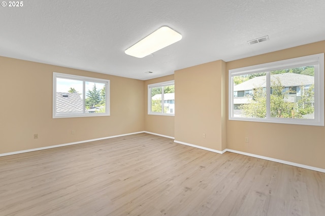 13055 Princeton Ct, Lake Oswego, OR 97035 - unfurnished room with light wood-type flooring, baseboards, and a textured ceiling