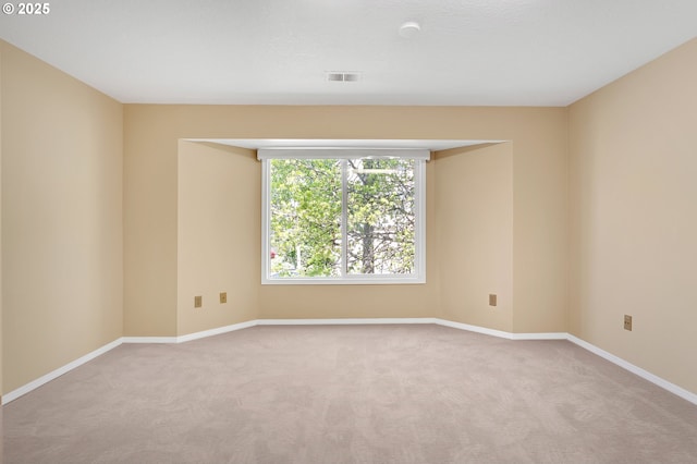 carpeted empty room with baseboards