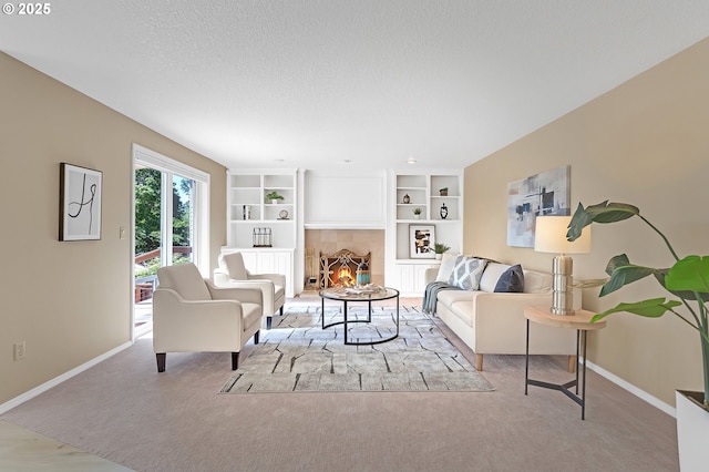 carpeted living room with baseboards, a textured ceiling, and built in features