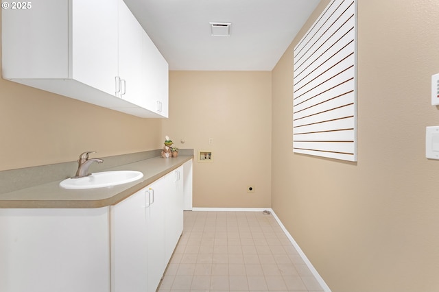 laundry area with cabinet space, washer hookup, hookup for an electric dryer, baseboards, and light tile patterned floors