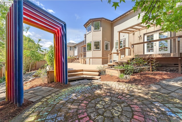 view of patio featuring a deck and fence